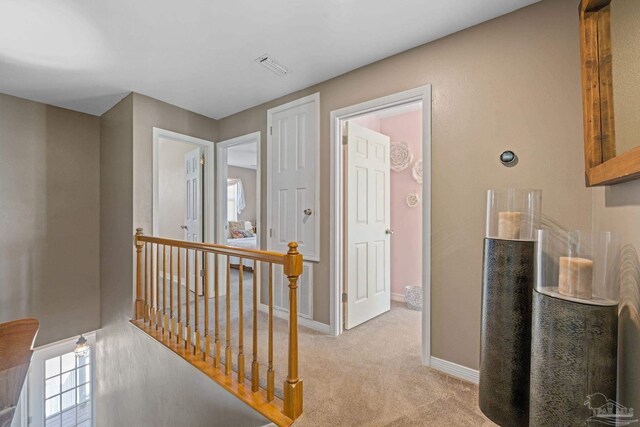 35868 Boykin Blvd, Lillian, AL 36549 - hall featuring baseboards, light carpet, visible vents, and an upstairs landing