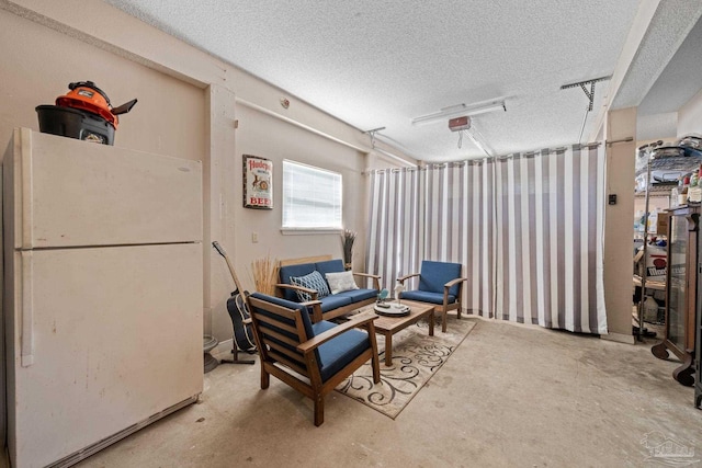 35868 Boykin Blvd, Lillian, AL 36549 - sitting room featuring a garage, a textured ceiling, and unfinished concrete flooring