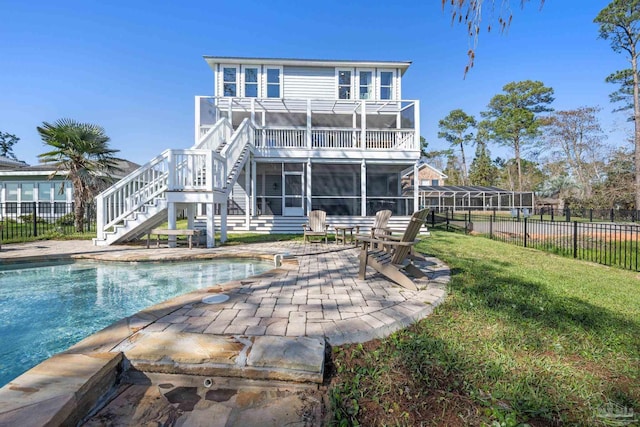 35868 Boykin Blvd, Lillian, AL 36549 - back of property with a fenced in pool, a lawn, a sunroom, fence, and stairs