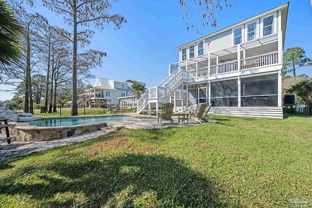 35868 Boykin Blvd, Lillian, AL 36549 - rear view of house with a sunroom, stairs, fence, and a lawn