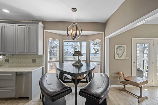 35868 Boykin Blvd, Lillian, AL 36549 - dining room with a chandelier, light wood-type flooring, and baseboards
