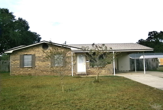 ranch-style house featuring a front lawn and a carport