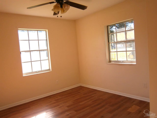 unfurnished room with ceiling fan and dark hardwood / wood-style flooring