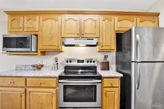 kitchen featuring light stone countertops and appliances with stainless steel finishes