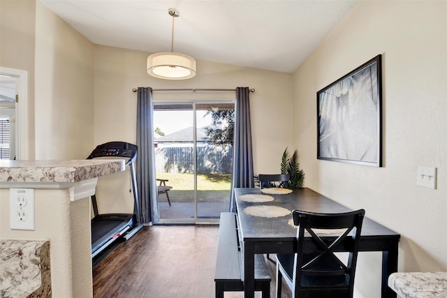 dining area with lofted ceiling and dark wood-type flooring