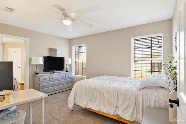 bedroom featuring light carpet and ceiling fan