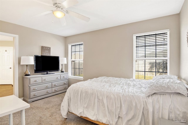 bedroom featuring light colored carpet and ceiling fan