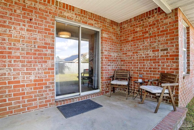 view of exterior entry with a patio area