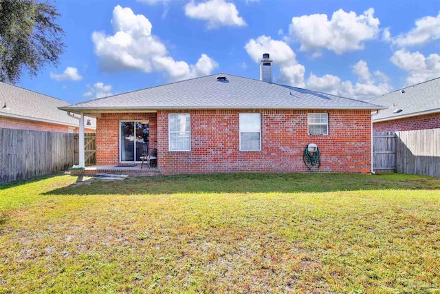 back of property featuring a yard