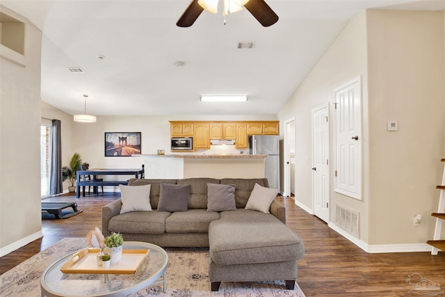 living room featuring dark wood-type flooring, ceiling fan, and lofted ceiling