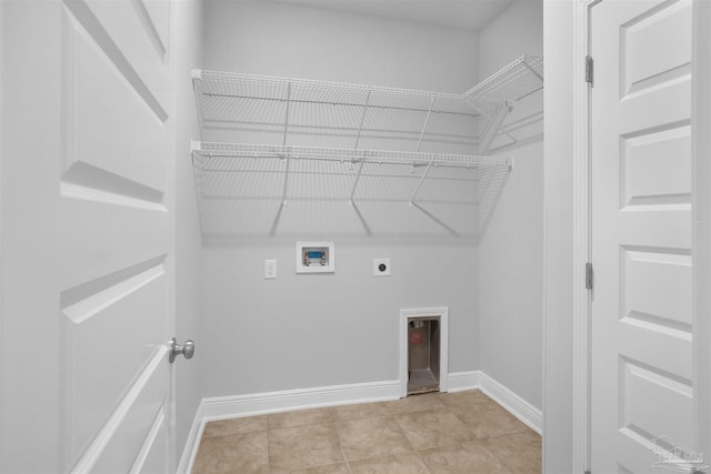 washroom with hookup for a washing machine, light tile patterned floors, and hookup for an electric dryer