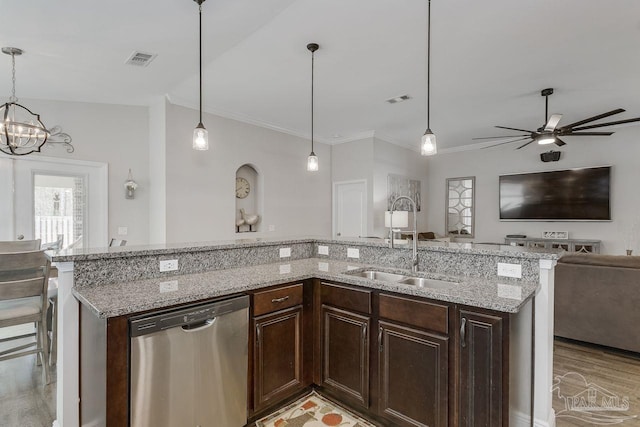 kitchen featuring dark brown cabinets, stainless steel dishwasher, light wood-type flooring, decorative light fixtures, and light stone counters