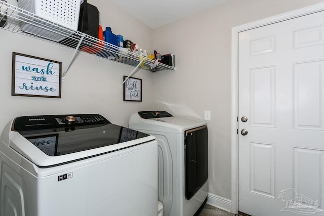 clothes washing area featuring separate washer and dryer