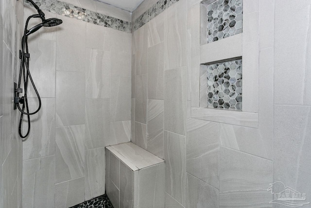 bathroom with tiled shower