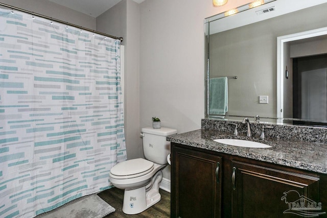 bathroom with vanity, wood-type flooring, toilet, and walk in shower