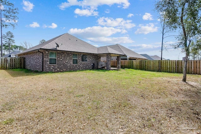 rear view of house featuring a lawn