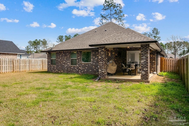 rear view of property with a patio area and a yard