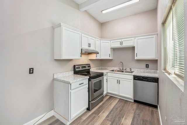 kitchen with appliances with stainless steel finishes, white cabinetry, sink, and hardwood / wood-style flooring