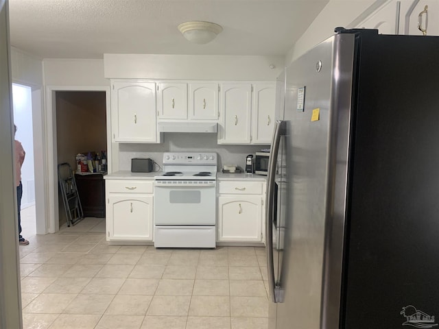 kitchen featuring light tile patterned flooring, appliances with stainless steel finishes, white cabinets, and a textured ceiling