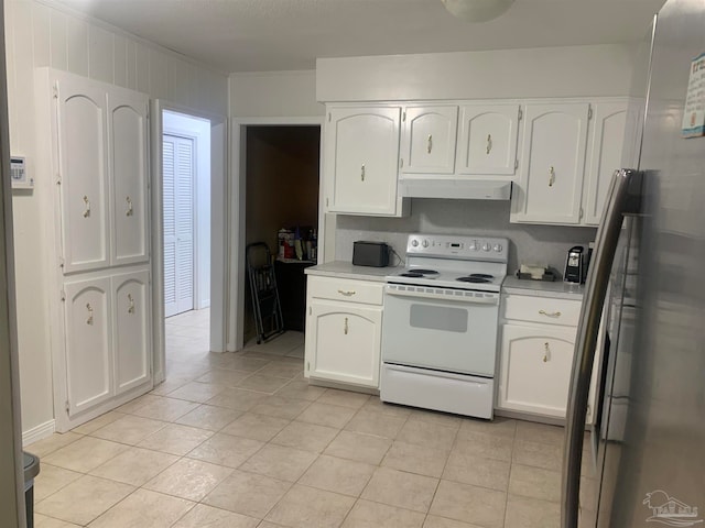 kitchen featuring crown molding, stainless steel refrigerator, white cabinetry, white electric range oven, and light tile patterned flooring