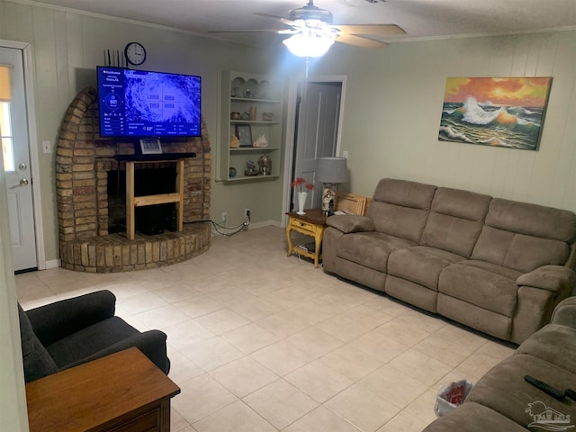 living room with built in features, a fireplace, ornamental molding, and ceiling fan