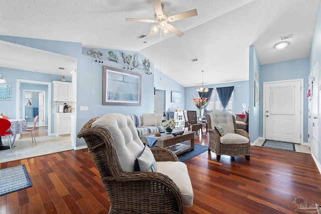 living room featuring lofted ceiling, visible vents, ceiling fan, and hardwood / wood-style floors