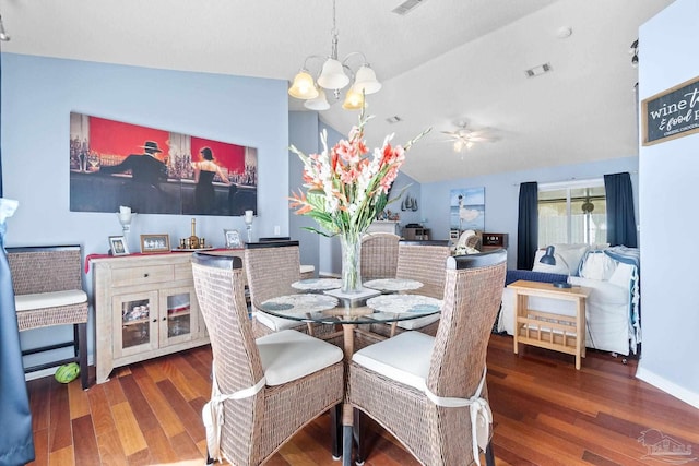 dining room featuring lofted ceiling, visible vents, an inviting chandelier, and wood finished floors