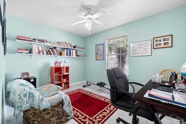 office with ceiling fan, a textured ceiling, and baseboards