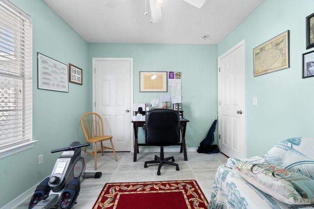 office area featuring ceiling fan and baseboards