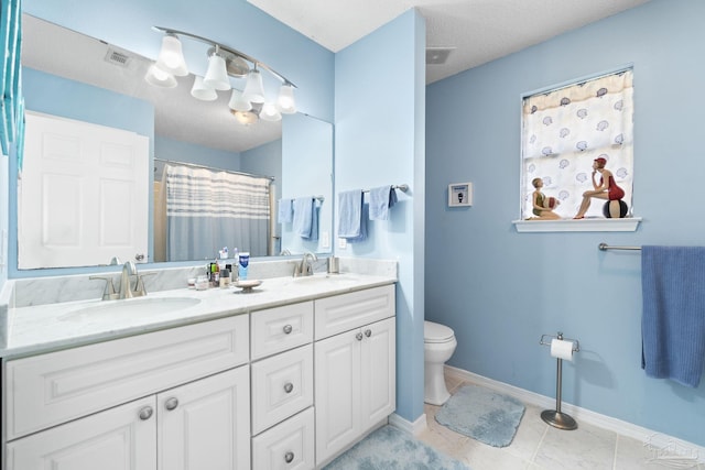 bathroom featuring toilet, visible vents, and a sink