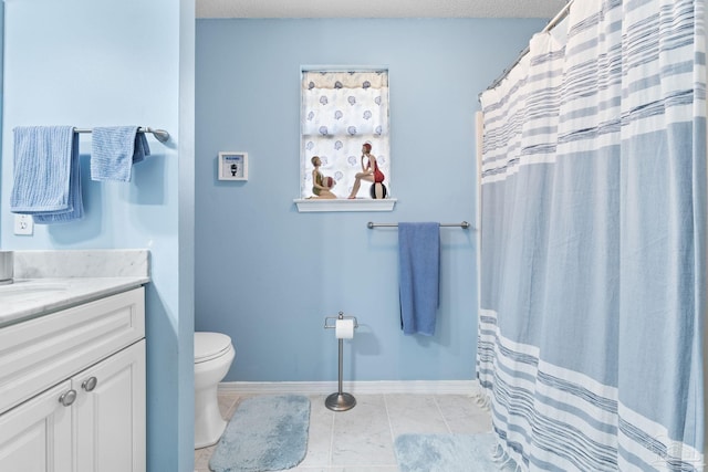 bathroom featuring baseboards, a shower with shower curtain, toilet, tile patterned flooring, and vanity