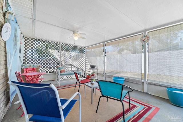 sunroom featuring a ceiling fan