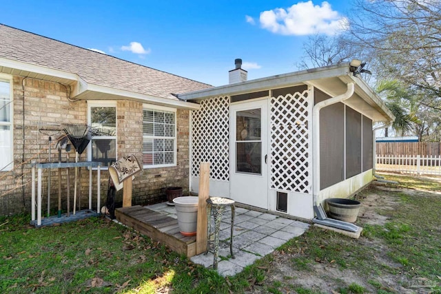 back of property featuring a patio area, a shingled roof, a chimney, and fence