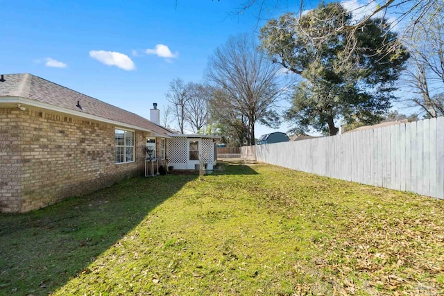 view of yard with a fenced backyard