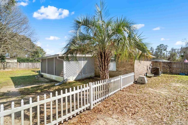 view of yard with fence private yard and a sunroom