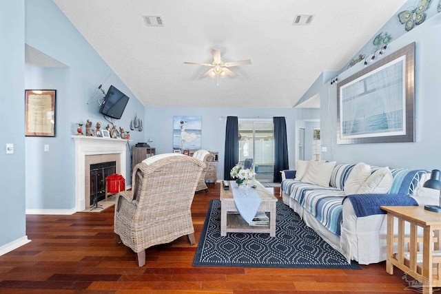 living area with lofted ceiling, visible vents, and wood finished floors