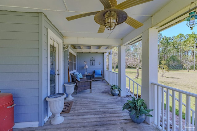 deck with covered porch and ceiling fan