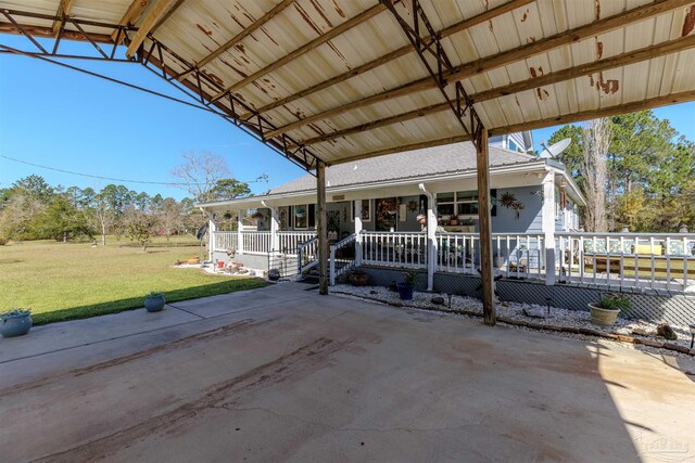 farmhouse inspired home with a front lawn, a carport, and a porch