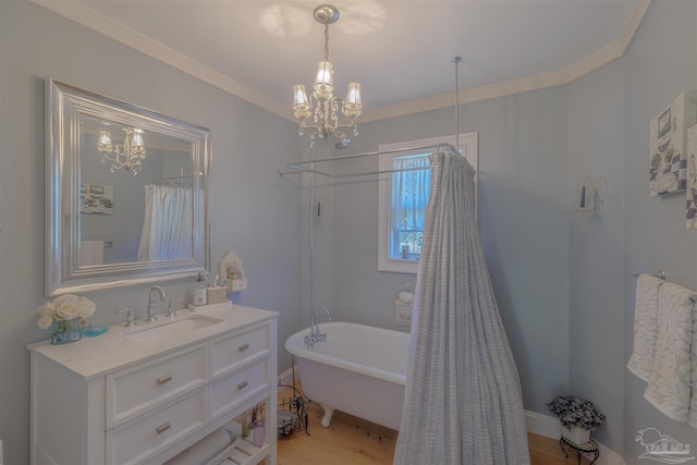 full bathroom featuring a soaking tub, wood finished floors, vanity, and a chandelier