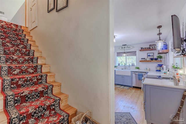 stairway with visible vents and wood finished floors