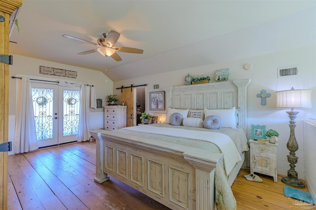 bedroom featuring access to exterior, vaulted ceiling, french doors, light wood-type flooring, and visible vents