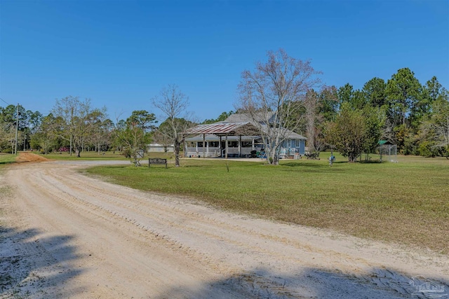 view of front of property with driveway and a front lawn