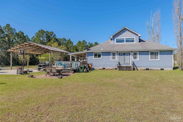back of house featuring a yard, crawl space, entry steps, and a carport