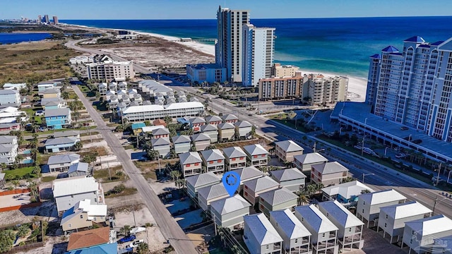 drone / aerial view featuring a water view and a beach view