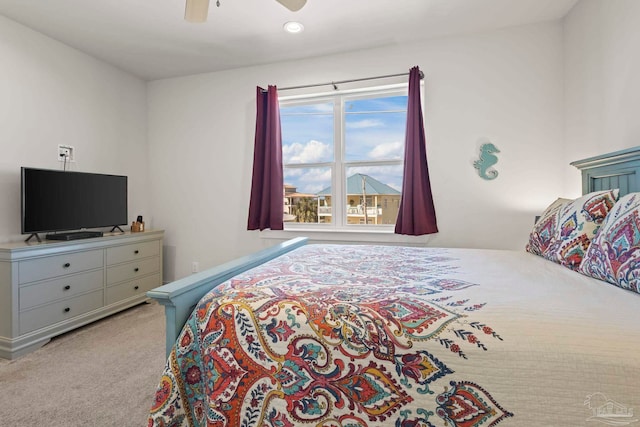 bedroom with ceiling fan and light carpet