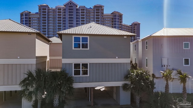 rear view of property with a carport