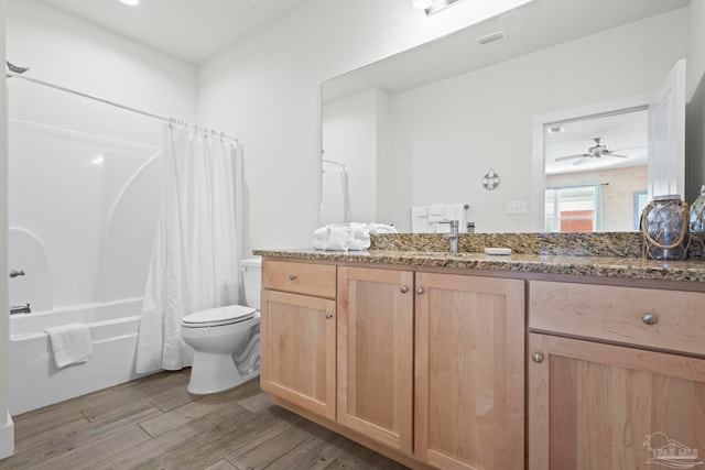 full bathroom with vanity, ceiling fan, toilet, shower / bathtub combination with curtain, and wood-type flooring