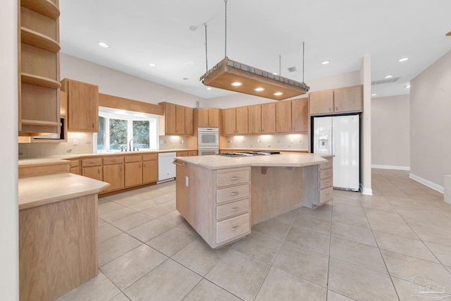 kitchen featuring open shelves, tasteful backsplash, light countertops, a kitchen island, and white appliances