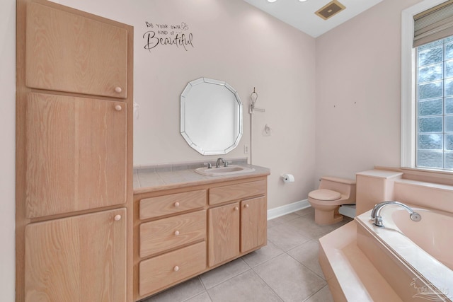 bathroom with a garden tub, toilet, vanity, visible vents, and tile patterned floors