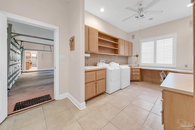 laundry room with cabinet space, light tile patterned floors, washing machine and clothes dryer, a sink, and recessed lighting